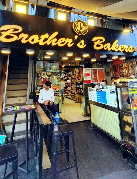 Brother's Bakers shopfront sign, Tagore Garden, lit up in the evening